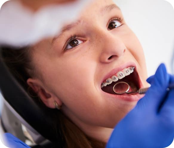 girl-with-braces-routine-dental-examination