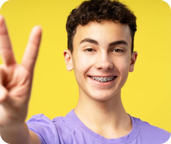 portrait-positive-handsome-boy-with-braces-gesturing-showing-peace-sign-with-fingers